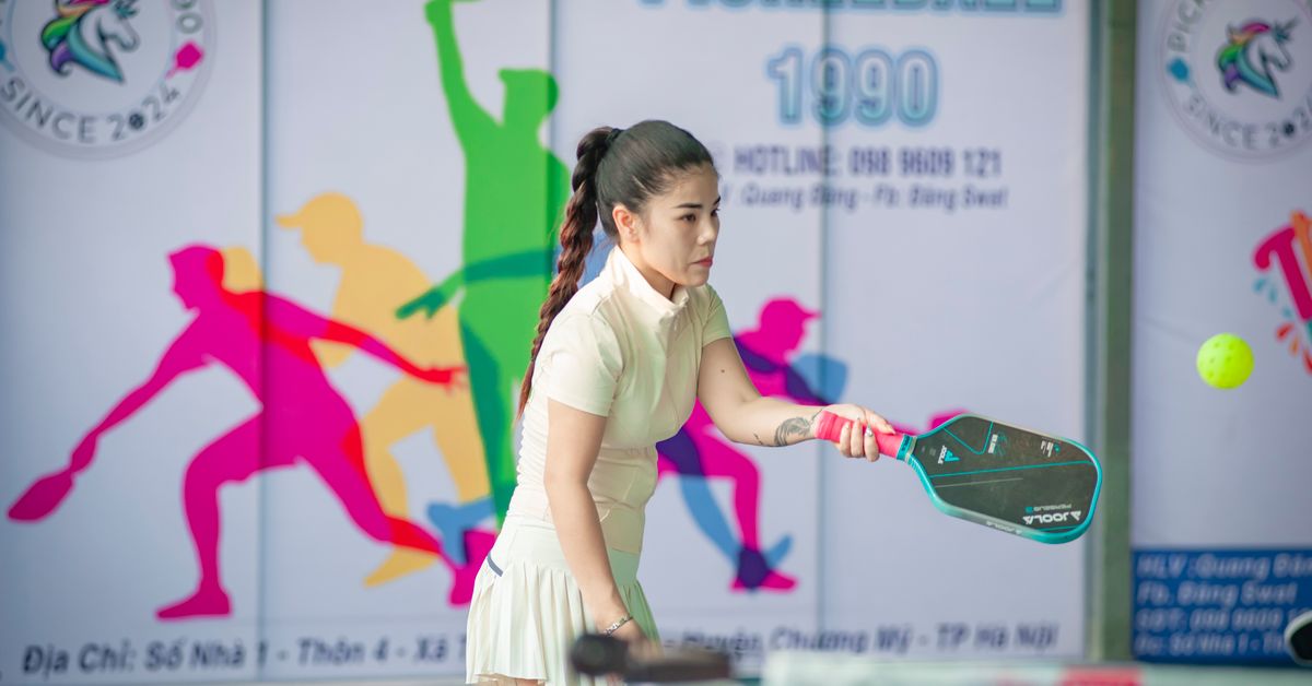 Woman playing pickleball on an outdoor court