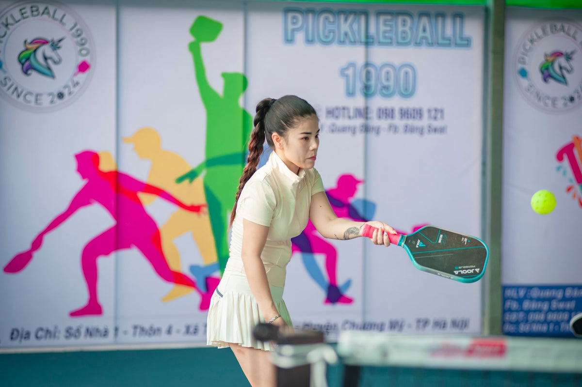 Woman playing pickleball outdoors