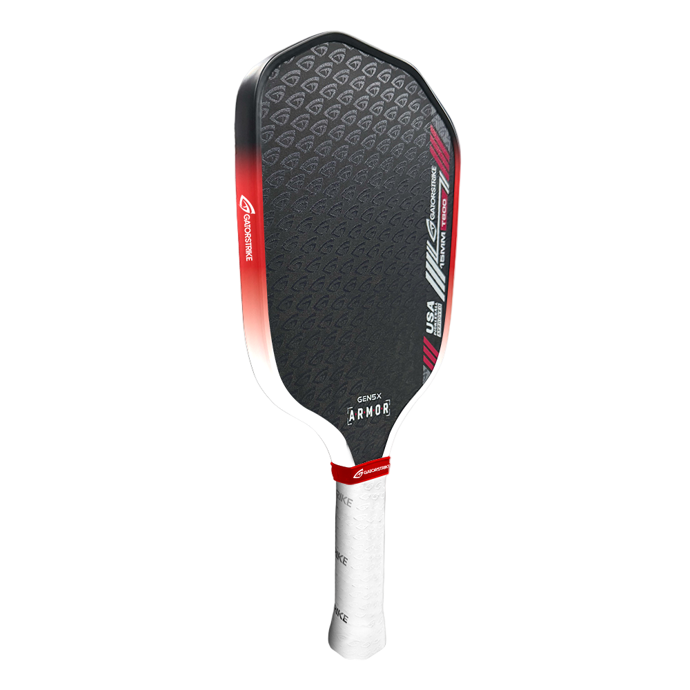 A black pickleball paddle with a textured hexagonal pattern, red and white accents, and the “GATORSTRIKE” brand name near the handle. It’s designed for stability and control with a tapered handle, white grip tape, and red “ARMOR” diagonal stripes.