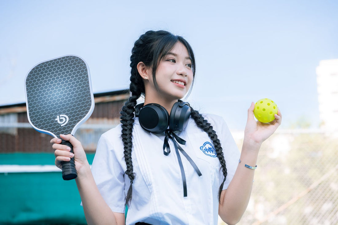 Player holding a pickleball paddle by the grip
