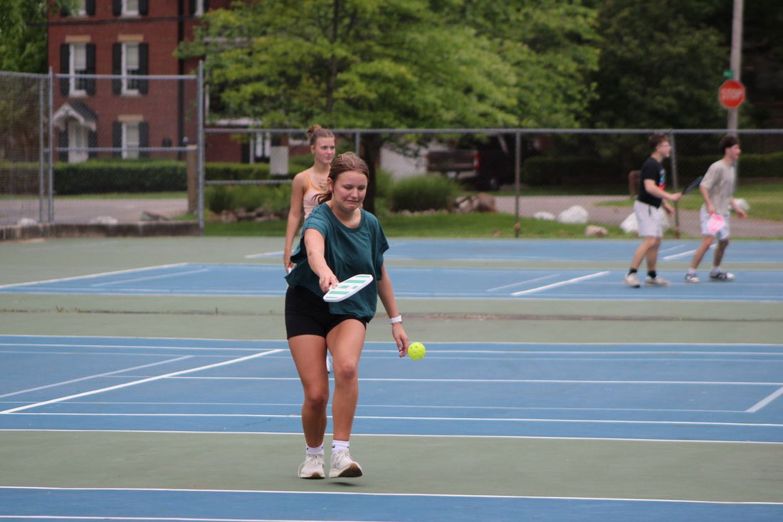 Group of players enjoying a friendly pickleball game outdoors