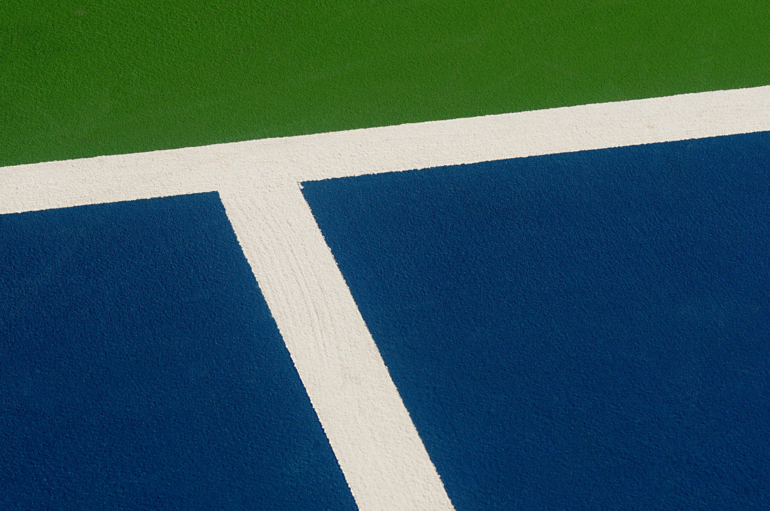 A pickleball player on court with a paddle