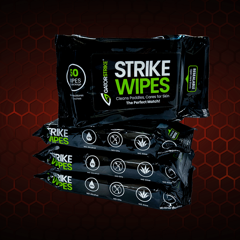 Four packs of black GatorStrike Strike Wipes, labeled for cleaning paddles and skin. Each pack contains 50 wipes and highlights features like no alcohol, no oils, and no rinse needed.