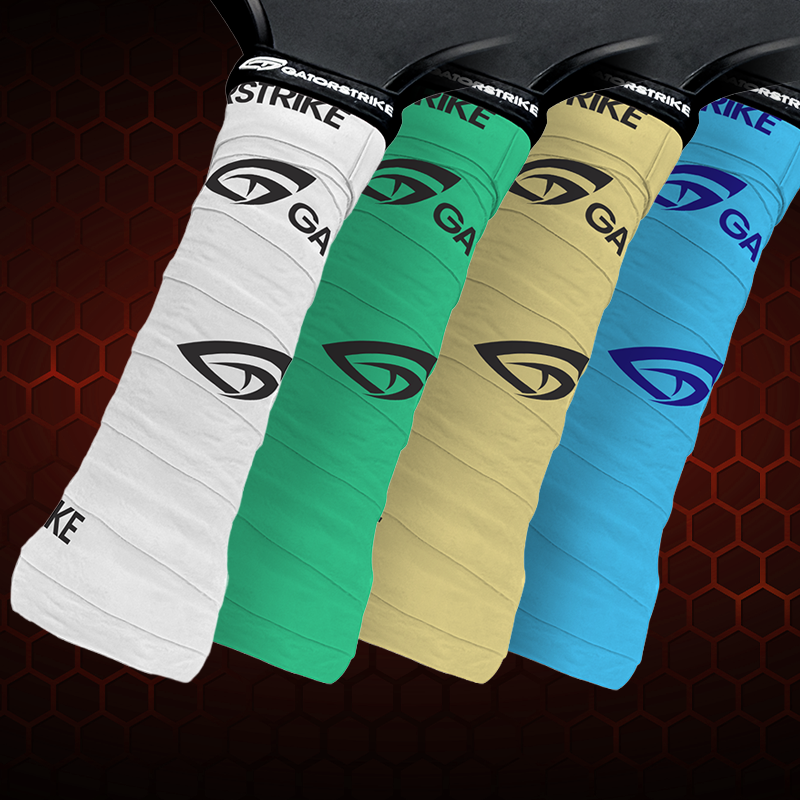 Five paddle or racquet grips in white, green, yellow, blue, and black are lined up side by side. Each grip features the GatorStrike logo and text in contrasting colors.