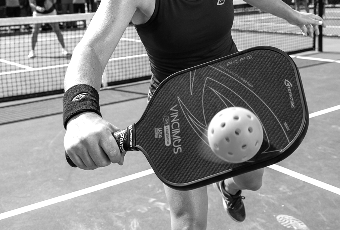 Three black pickleball paddles with colorful accents (blue, pink, and green), each labeled “VINCIMUS” and “GATORSTRIKE,” standing upright with textured black grips and modern graphic designs.