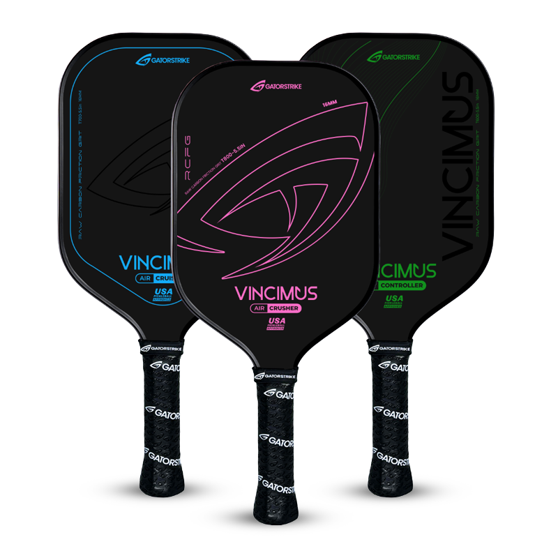 Three black pickleball paddles with colorful accents (blue, pink, and green), each labeled “VINCIMUS” and “GATORSTRIKE,” standing upright with textured black grips and modern graphic designs.