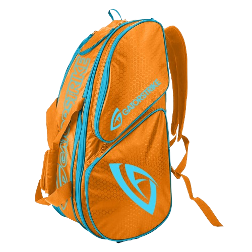 An orange GATORSTRIKE sports paddle bag with light blue zippers and accents, featuring the GATORSTRIKE logo in blue. Designed for athletic gear or paddles, it has multiple compartments, padded straps, and a textured surface on a plain light gray background.