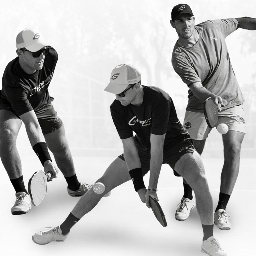 Three men in sportswear play pickleball outdoors, following a GatorStrike pickleball manual as they aim for precise shots.