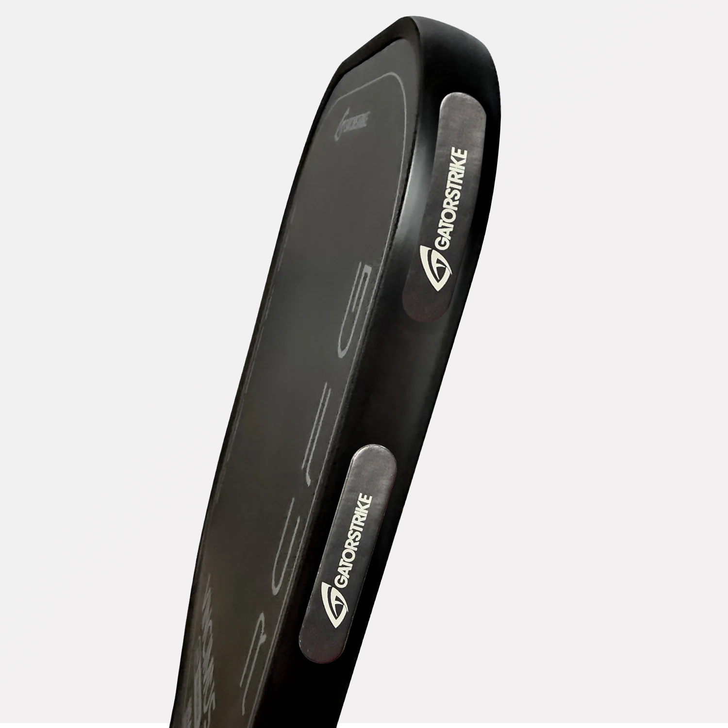 Black rectangular kick pad angled upward, features paddle weights for stronger swings and white “GanoStrike” logo on handles.