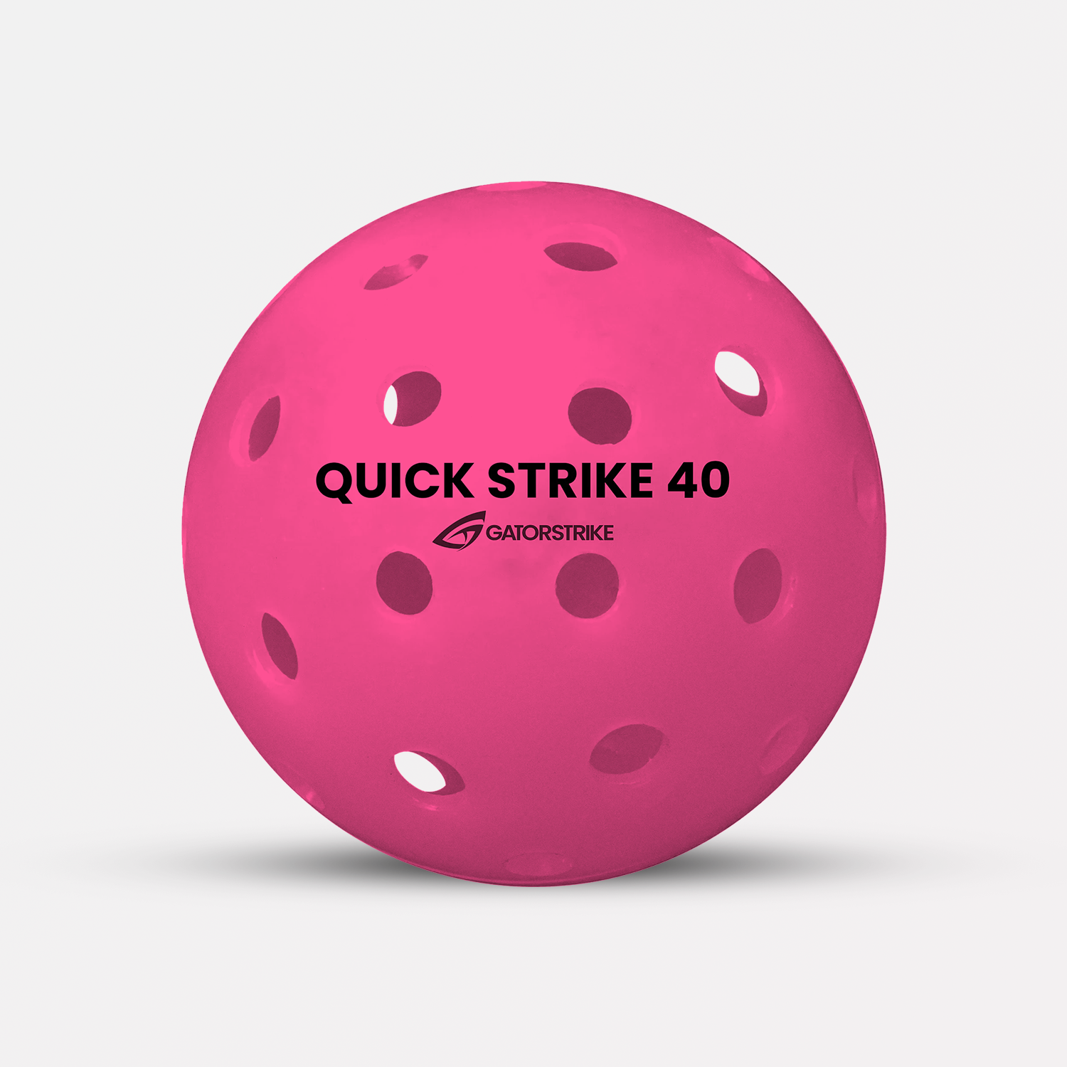 A pink perforated plastic ball labeled Quick Strike 40 GATORSTRIKE, made for outdoor competitive play.