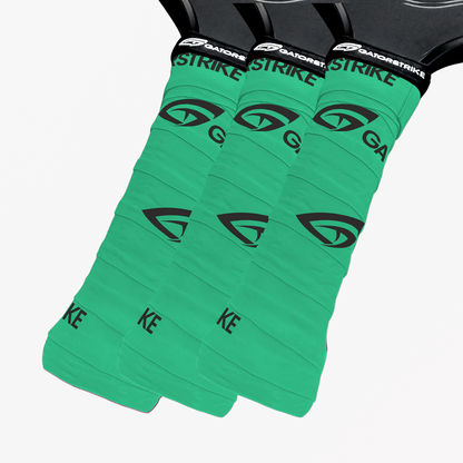 Three green GatorStrike grip tapes on black handles, each featuring a black logo and GatorStrike pickleball manual text.