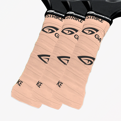 Three tan GatorStrike pickleball grips overlap on a white background, perfect for fans of the official pickleball rules.