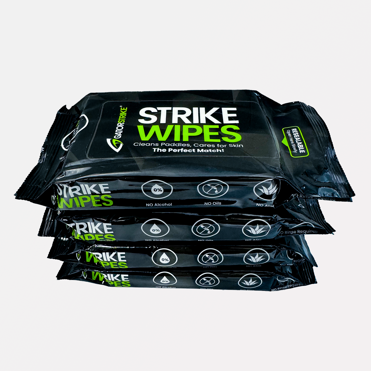 Four stacked black packs of Strike Wipes for cleaning, each labeled with green and white text and GatorStrike pickleball manual.