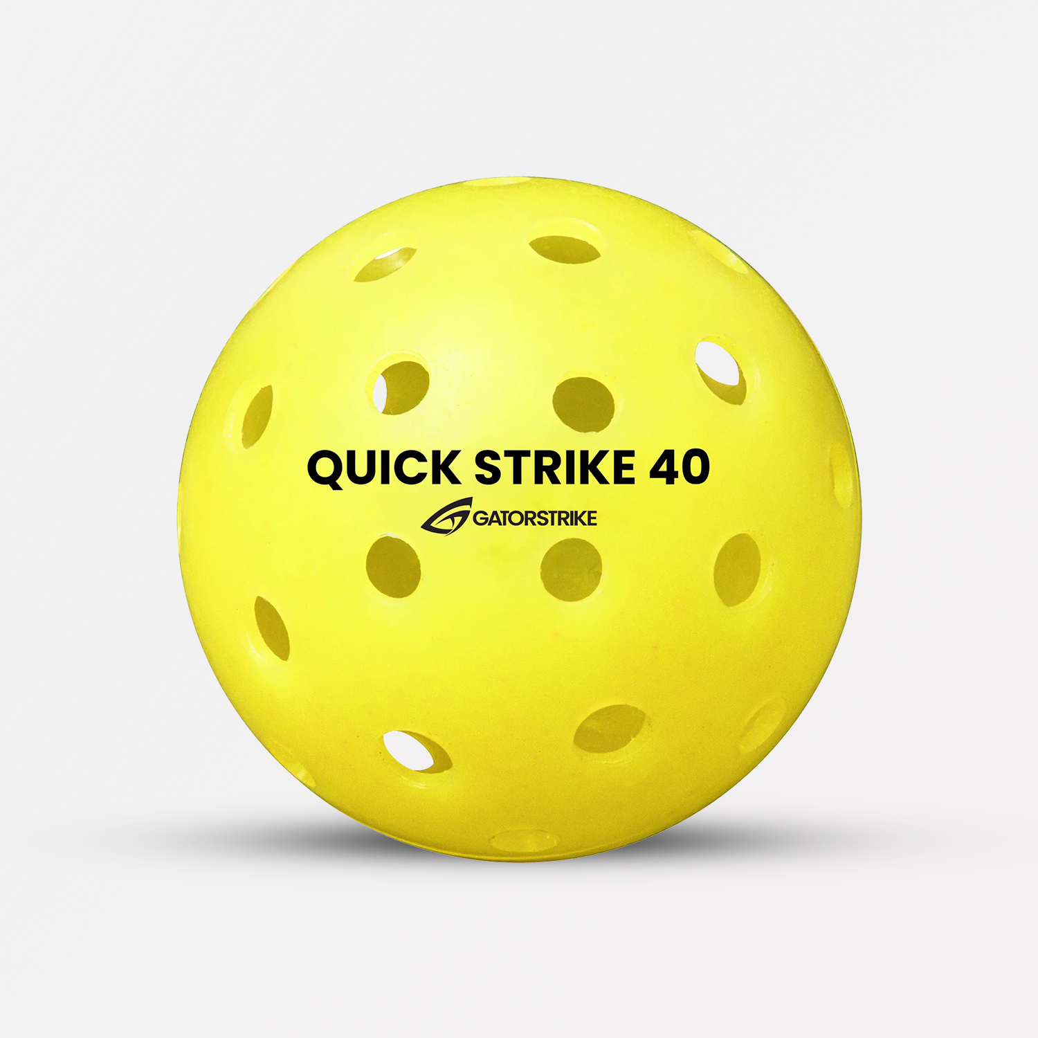 A yellow high-impact polymer Quick Strike 40 ball with holes, perfect for outdoor competitive play on a white background.